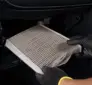 Technician checking a cabin air filter for wildfire smoke and summer debris