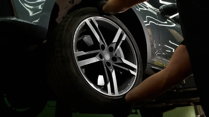Technician checking a tire and hub while diagnosing wheel bearing noise