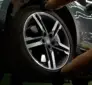 Technician checking a tire and hub while diagnosing wheel bearing noise