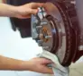 Technician inspecting a braking system after a driver reports a soft brake pedal