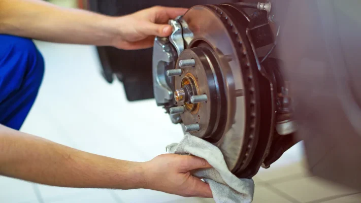 Technician inspecting a braking system after a driver reports a soft brake pedal