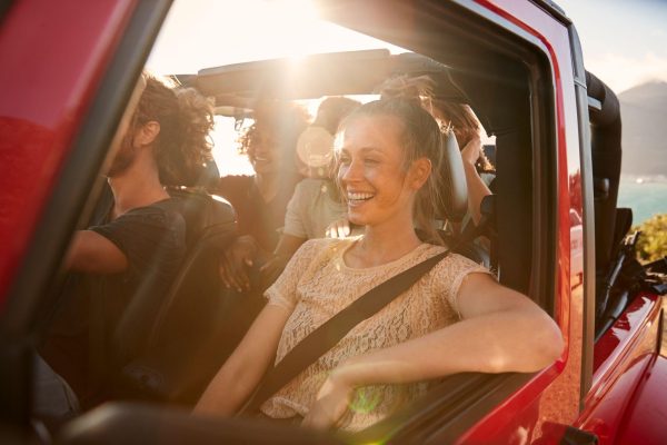 The Mufflerman, Mechanic Near Me A group of smiling friends enjoys a road trip in a red convertible under the bright sun. One woman, laughing in the passenger seat, embodies the spirit of summer fun. As they cruise along the sunny coastline with mountains behind, theyre reminded how preparation makes every journey unforgettable.