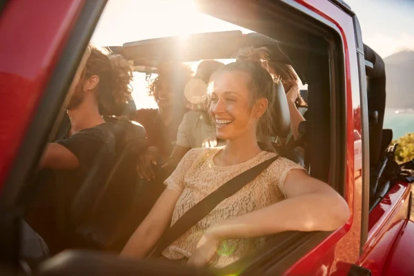 The Mufflerman, Mechanic Near Me A group of smiling friends enjoys a road trip in a red convertible under the bright sun. One woman, laughing in the passenger seat, embodies the spirit of summer fun. As they cruise along the sunny coastline with mountains behind, theyre reminded how preparation makes every journey unforgettable.